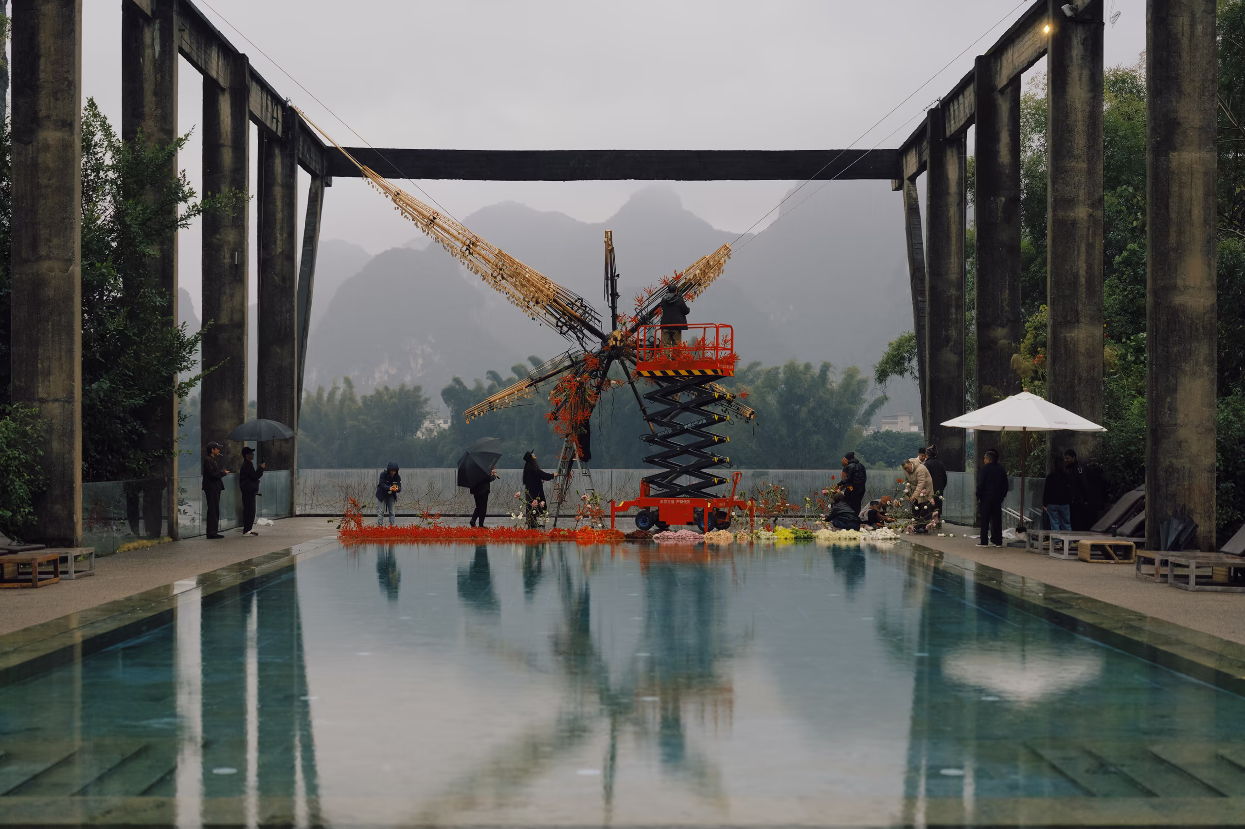 Floral artist Alfie Lin creating "The Unburnt" (Wei Jin), blending floral design with the carbonized structural remains of the "Super Star"
