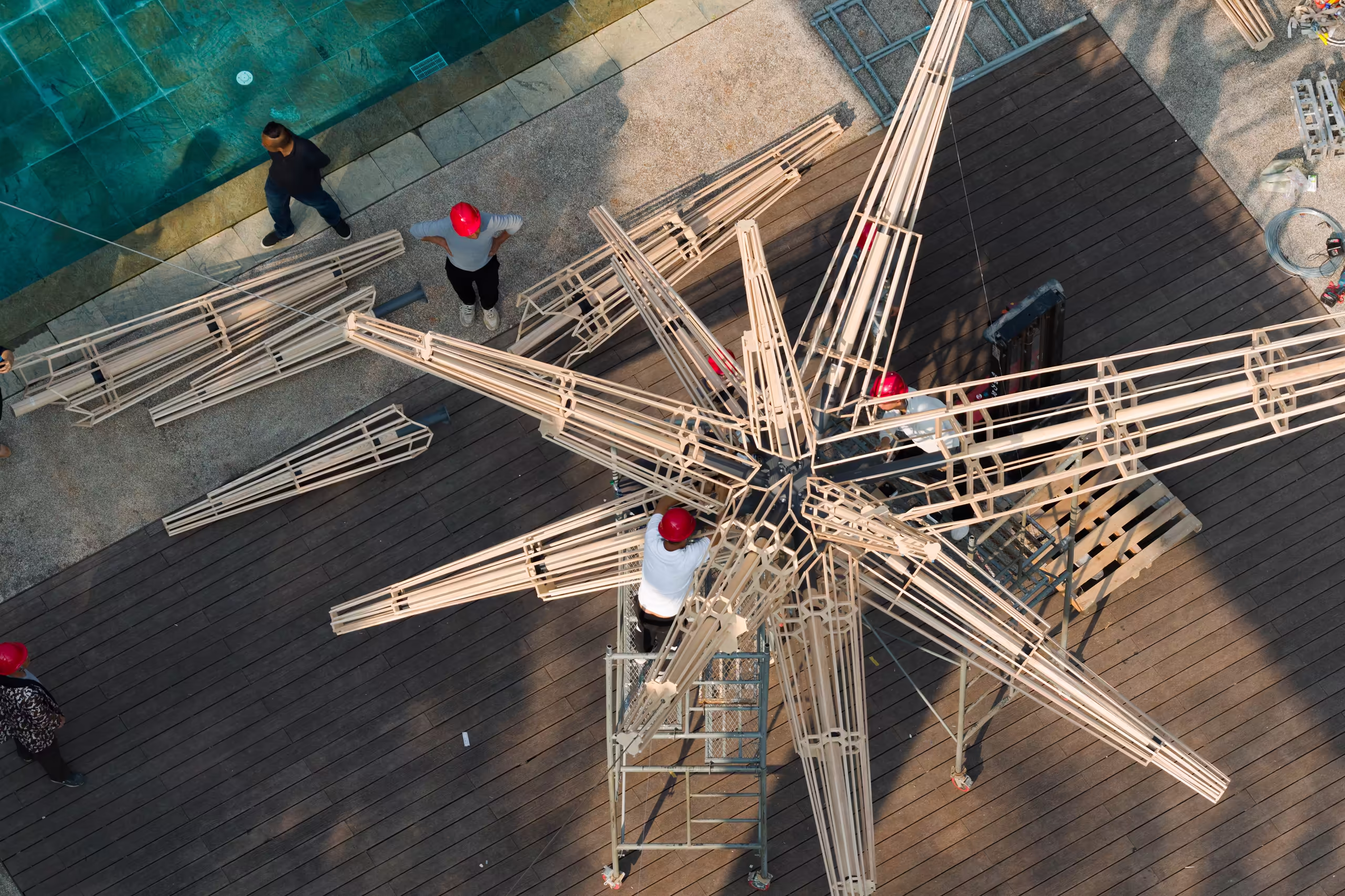 Workers assembling the "Super Star" burning installation on site